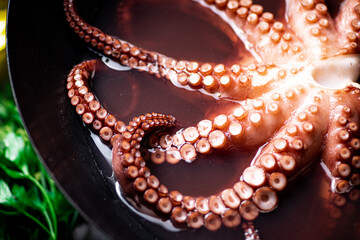 Octopus is boiled in a pot of water. 