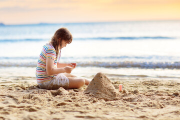 Little girl playing on tropical beach