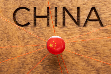 China flag on the pushpin with red thread showed the paths of movement or areas of influence in the...