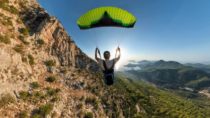 Man flying the paragliding at sunset. Adventure concept