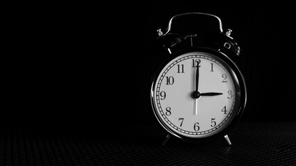 Background photo of an alarm clock showing 3:00