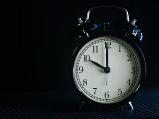 Background photo of an alarm clock showing 10:00
