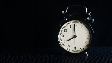 Background photo of an alarm clock showing 8:00
