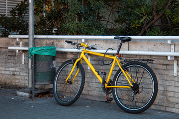Bicycle parked in the city, tied or padlocked to a bar to prevent it from being stolen