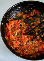 Neapolitan tomato sauce cooking in a pan, typical neapolitan ragu