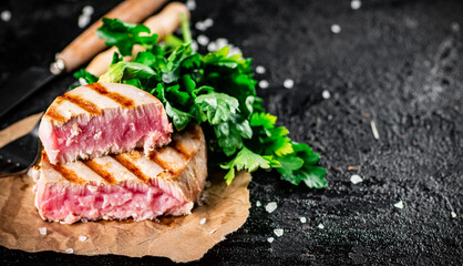 Grilled tuna with parsley on the table. 