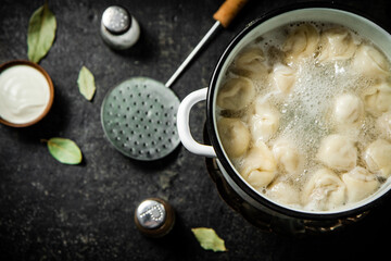 Dumplings in a pot of boiling water. 