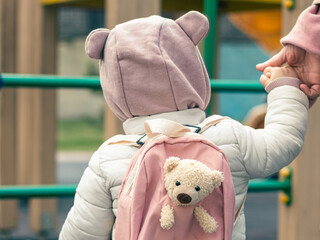 Little girl with her mom and backpack