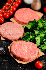 Raw burger with tomatoes and parsley. 