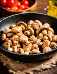 Homemade fried mushrooms in a frying pan. 