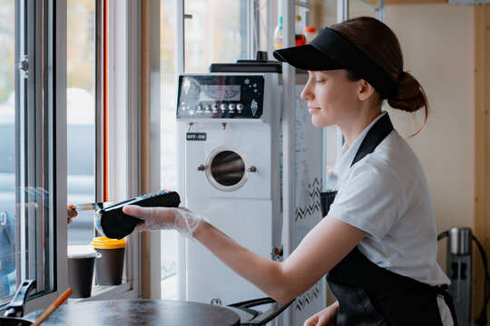Portrait woman chef baking pancakes in an apron uniform. Fast food service of the city. fast food restaurant is a small business.