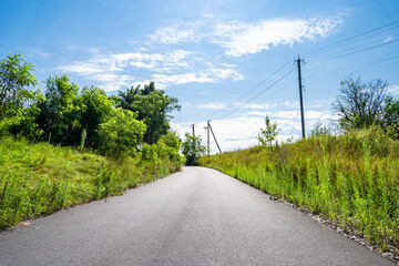 Fototapeta na wymiar Beautiful empty asphalt road in countryside on colored background