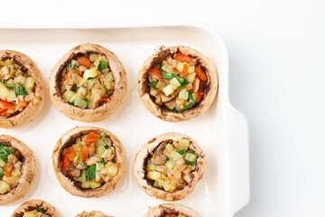 Mushrooms stuffed with vegetables on a baking dish
