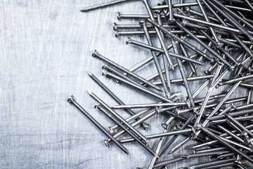 A bunch of nails on the table. 
