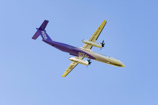 London, England - March 2019:  De Havilland Canada DHC8 Dash 8 turboprop aircraft operated by Flybe leaving London Heathrow Airport