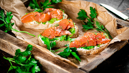 Salmon sandwich on a wooden tray. 