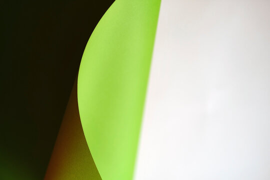 green wave from paper on white background with copy space. Concepts: lines and geometry. defocus abstract background.