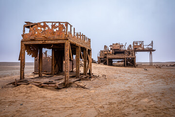 The rusted remains of an abandoned oil drilling rig between Henties Bay and Torra Bay, Skeleton Coast, Namibia.	