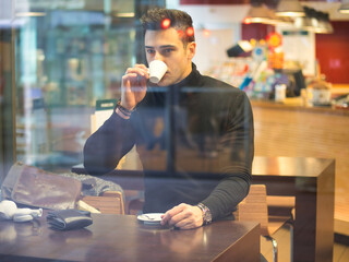 Man Drinking Coffee from Outside of the Bar Window