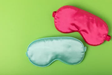  Sleeping mask on a green background. FLAT LAY. Concept of rest and quality of sleep. good night, insomnia, relaxation. © Avocado_studio