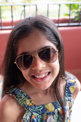 Indian Asian girl in sunglasses on a sunny day outdoors. 