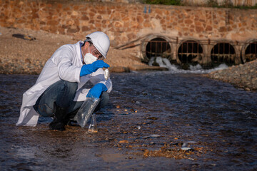 Worker under checking the waste water treatment pond industry large to control water support industry	