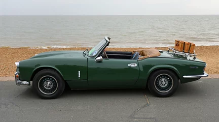 Poster Classic Green Spitfire Mk 4  motor  car with picnic basket on boot parked on Seafront Promenade beach and sea in background.  © harlequin9