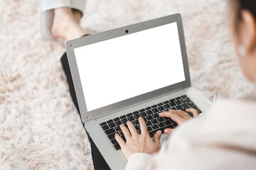 Blank white screen laptop with woman hand typing keyboard from back shoulder view