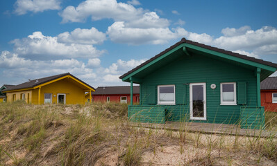 Fototapeta na wymiar Beautiful and colorful wooden houses on the beach of the island Heligoland - Dune.