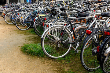 Fototapeta na wymiar A lot of old bicycles on the bike parking in the Netherlands.