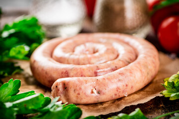 Round raw sausage on paper.