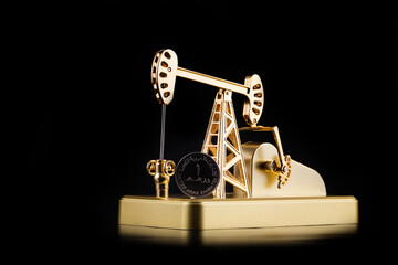 Gold oil pump and 1 United Arab Emirates dirham coin on black background