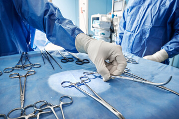 Close-up of sterilized and ready for use surgical instruments on medical tray during surgery...