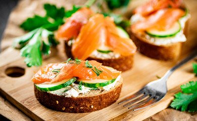 Salmon sandwich on a cutting board.