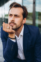 Image of young thinking businessman posing isolated over white wall background.