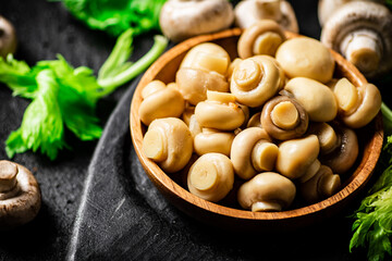 Delicious pickled mushrooms on a cutting board. 