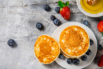 Homemade pancakes with berries on the table. 