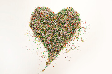 Frame in the shape of hearts. Background of multicolored decorative craft beads. Valentine's Day. Symbol of love.
