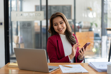 Young woman working with a laptop. Female freelancer connecting to internet via computer. Businesswoman at work.