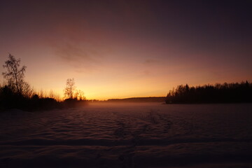 A beautiful sunset and misty Winter landscape
