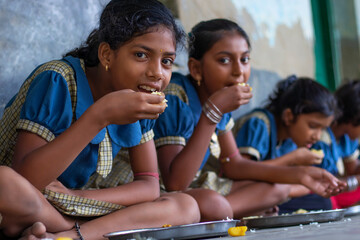 girls Student having mid day meal at school