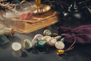 Rune Stones, Old Book and Crystals on Black