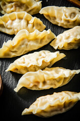 Dumplings gyoza with shrimp on a cutting board. 