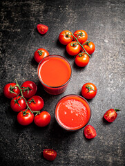 Fresh tomato juice. On a black background.