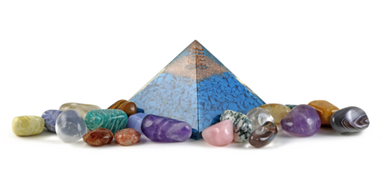 Copper spiral and clear quartz on top of blue chip stones inside Orgone pyramid surrounded by mixed tumbled healing stones transparent png file
