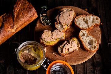 French baguette with foie gras on a wooden surface. Cooking bruschetta with goose liver. © Konstiantyn Zapylaie