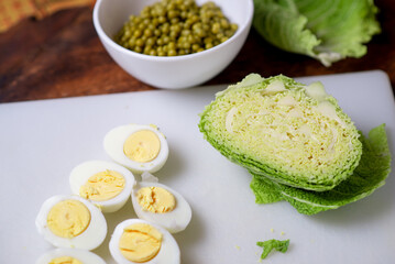Savoy cabbage salad. Cooking. Green peas, chicken eggs and cabbage. Ingredients.