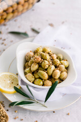 Various olives flavored with spices in white cup and glass jar. Green olives, black olives. Front and top shot on a white background