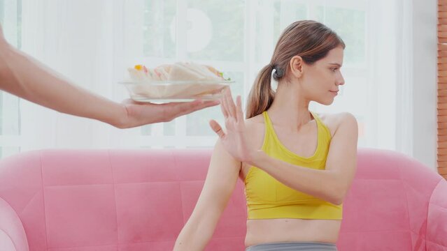 Hands serving food and young caucasian woman making sign say no food unhealthy with obese, woman refuse and push out food with temptation for dieting, nutrition and fast food a bad, health concepts.