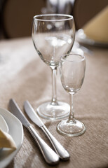 empty goblets and other cutlery are served on the festive table.